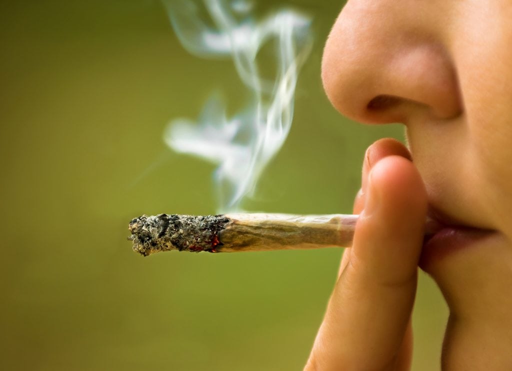 girl smoking handmade cigarette marijuana close up ** Note: Visible grain at 100%, best at smaller sizes